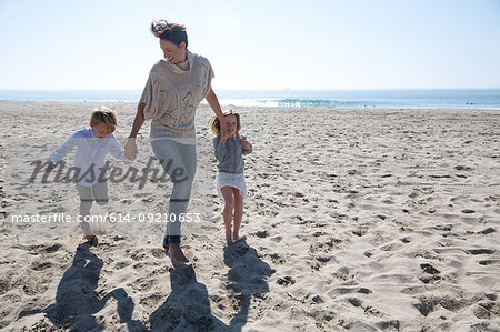 Mother holding hands with son and daughter, Newport Beach, California, USA