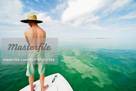 Young man standing on boat, Islamorada, Florida Keys, USA