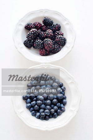 Bowls of blueberries and blackberries