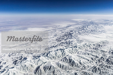 Aerial view of snow covered mountain range, Western China, East Asia