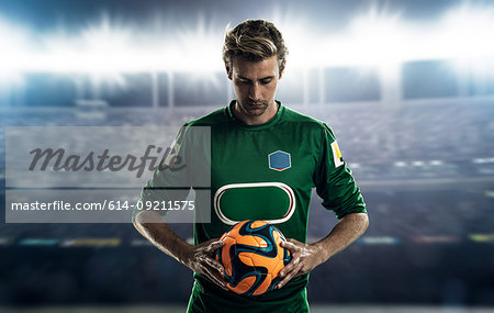 Footballer holding ball