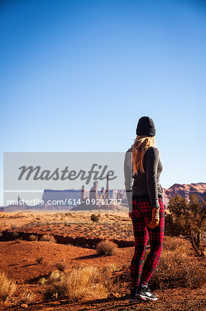 Rear view of mid adult woman looking out at Monument Valley, Utah, USA