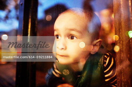 Boy looking through window