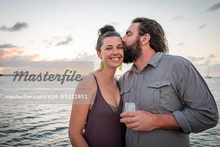 Man kissing girlfriend on cheek at coast, Islamorada, Florida, USA