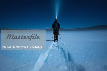 Man cross country skiing in moonlight, Carmi Cross Country Ski Loop, Penticton, British Columbia, Canada
