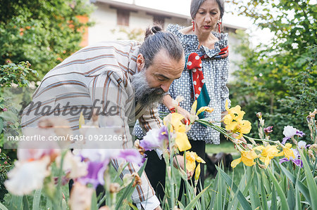 Couple picking flowers from garden