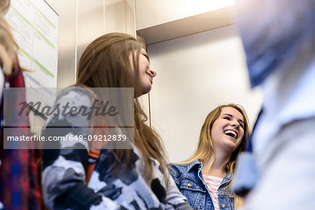 University students talking inside elevator