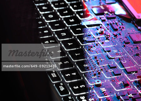 Multiple exposure of laptop computer showing keyboard and circuit board below