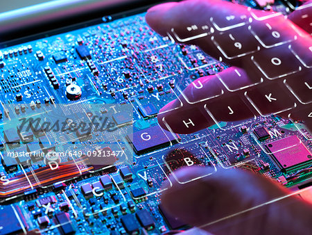 Multiple exposure of a laptop computer showing  a invisible computer hacker working at a keyboard and circuit board below