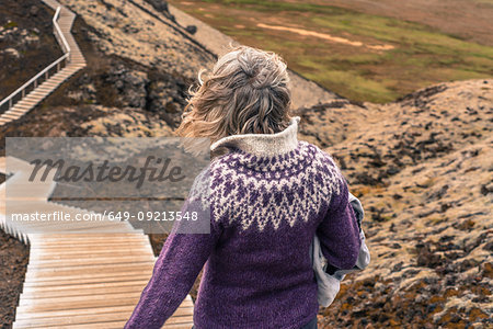 Woman walking around Grabrok volcano, Iceland