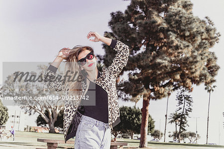 Hip young woman dancing in park