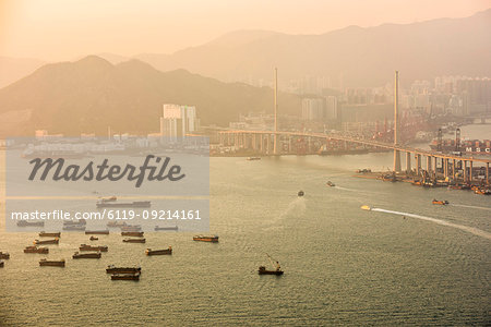 Boats in Victoria Harbour at sunset, seen from Victoria Peak, Hong Kong Island, Hong Kong, China, Asia