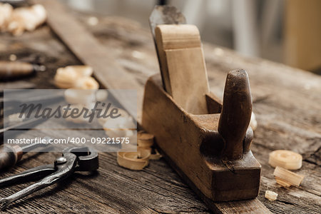 Wood planer on the carpenter's workbench and old woodworking tools, carpentry and do it yourself concept