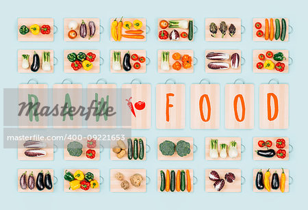 Raw food and healthy eating: fresh organic vegetables on chopping boards collection and text