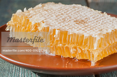 Fresh honeycombs on a wooden table closeup, selective focus