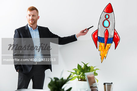 Businessman drawing a fast rocket. Concept of business improvement and enterprise startup