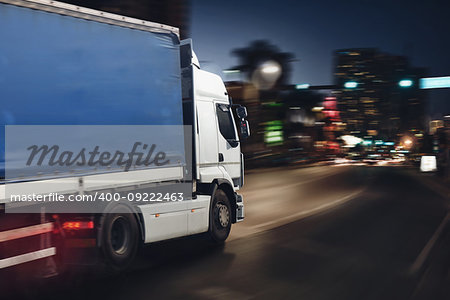 Moving truck on a city road with skyscrapers background