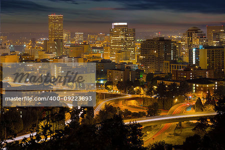 Portland Oregon downtown cityscape and freeway with light trails at night