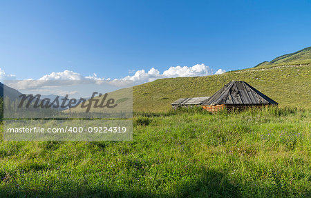 Abandoned cattle-ranch. Altai Mountains, Russia. Sunny summer day.