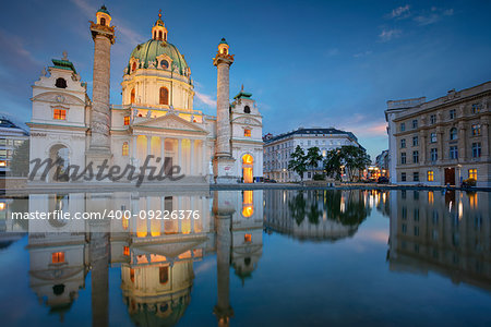 Cityscape image of Vienna with St. Charles Church during twilight blue hour.