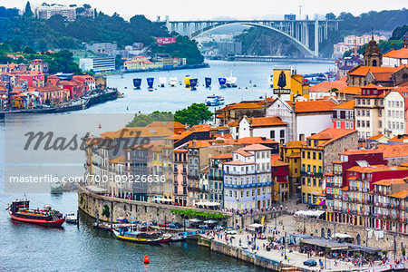 Overview of harbor and waterfront with the Arrabida Bridge in the background in Porto, Norte, Portugal