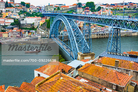 Dom Luis I Bridge and harbor with clay tiled rooftops in Porto, Norte, Portugal