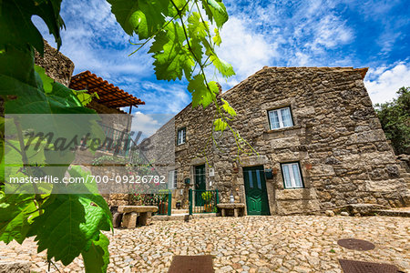 Cobblestone courtyard with traditional stone hours in the village of Monsanto, Idanha-a-Nova, Portugal