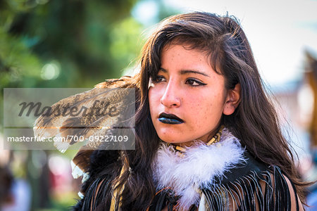 Young, female indigenous tribal dancer at a St Michael Archangel Festival parade in San Miguel de Allende, Mexico
