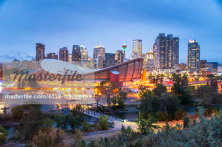 View of the Saddledome and Downtown skyline from Scottsman Hill at dusk, Calgary, Alberta, Canada, North America