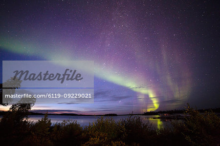 The Northern Lights (aurora borealis) in the night sky above Lake Egenolf in northern Manitoba, Canada, North America