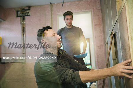 Construction workers framing inside of house