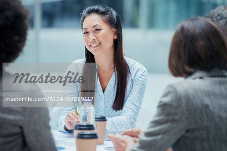 Smiling businesswoman in conference room meeting