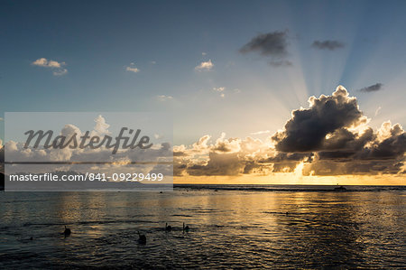 Snorkelers at sunset at Niau Atoll, Tuamotus, French Polynesia, South Pacific, Pacific