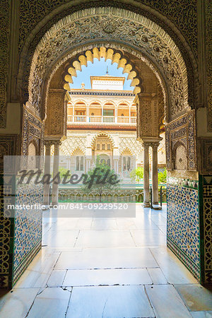 Patio de las Doncellas from interior of a room decorated with mosaic tiled and archways, Real Alcazar, UNESCO World Heritage Site, Seville, Andalusia, Spain, Europe