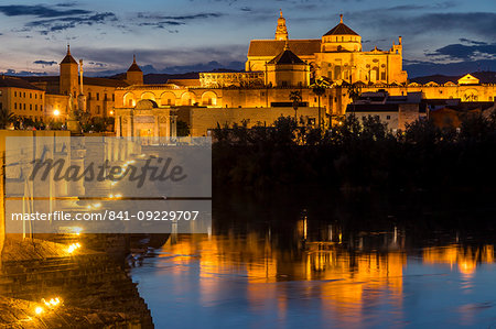 The illuminated Mosque-Cathedral (Great Mosque of Cordoba) (Mezquita) and the Roman Bridge at dusk, UNESCO World Heritage Site, Cordoba, Andalusia, Spain, Europe