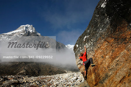 Climber bouldering at Tangnag moraine, Khumbu, Himalayas, Nepal, Asia