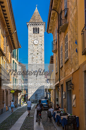 View of clock tower on Via Umberto l, cobbled street in Cannobio, Lake Maggiore, Piedmont, Italy, Europe