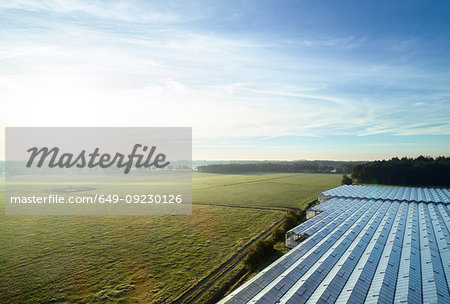 Field landscape with plant nursery greenhouse roof at sunrise, elevated view, Netherlands