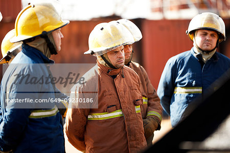 Firemen training, team of firemen listening to supervisor at training facility