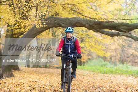 Senior woman cycling in park