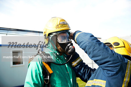Firemen training to put on fire helmet, Darlington, UK