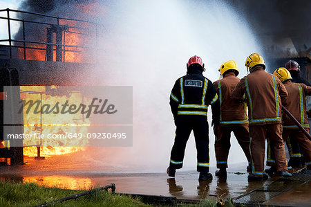 Firemen training to put out fire on burning building, Darlington, UK