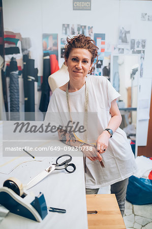 Portrait of fashion designer in her work studio