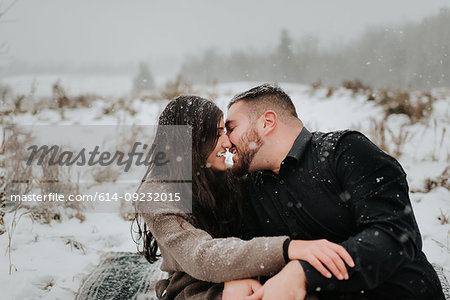 Couple kissing in snow, Georgetown, Canada