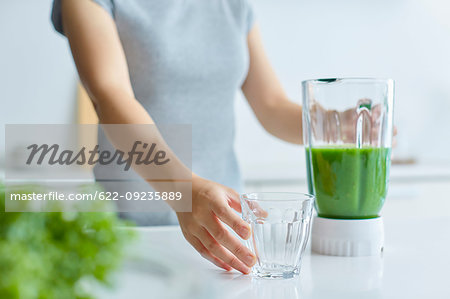 Japanese woman making smoothie in the kitchen