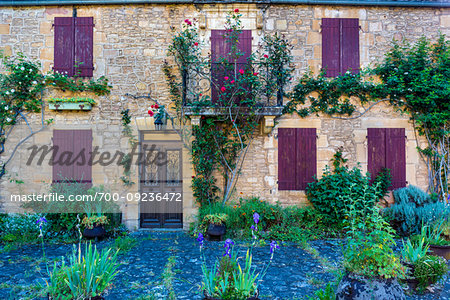 Entrance ot old, stone building in Saint-Leon-sur-Vezere in Dordogne, Nouvelle-Aquitaine, France.