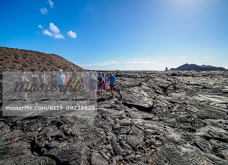 Tourists visiting Lava field in Sullivan Bay, Santiago (James) Island, Galapagos, UNESCO World Heritage Site, Ecuador, South America