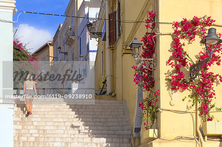 A tourist walks up steps at Carloforte, San Pietro Island, Sud Sardegna province, Sardinia, Italy, Mediterranean, Europe