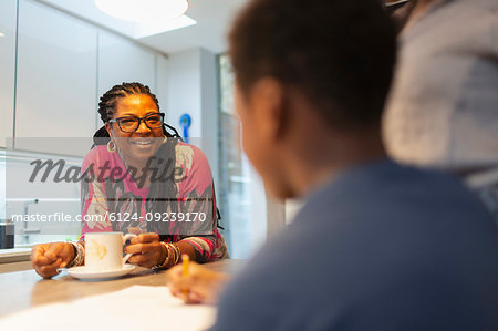 Smiling grandmother talking to grandson in kitchen