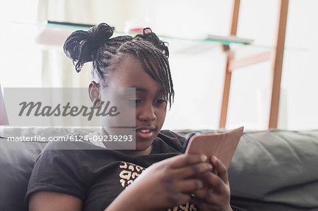 Tween girl texting with smart phone